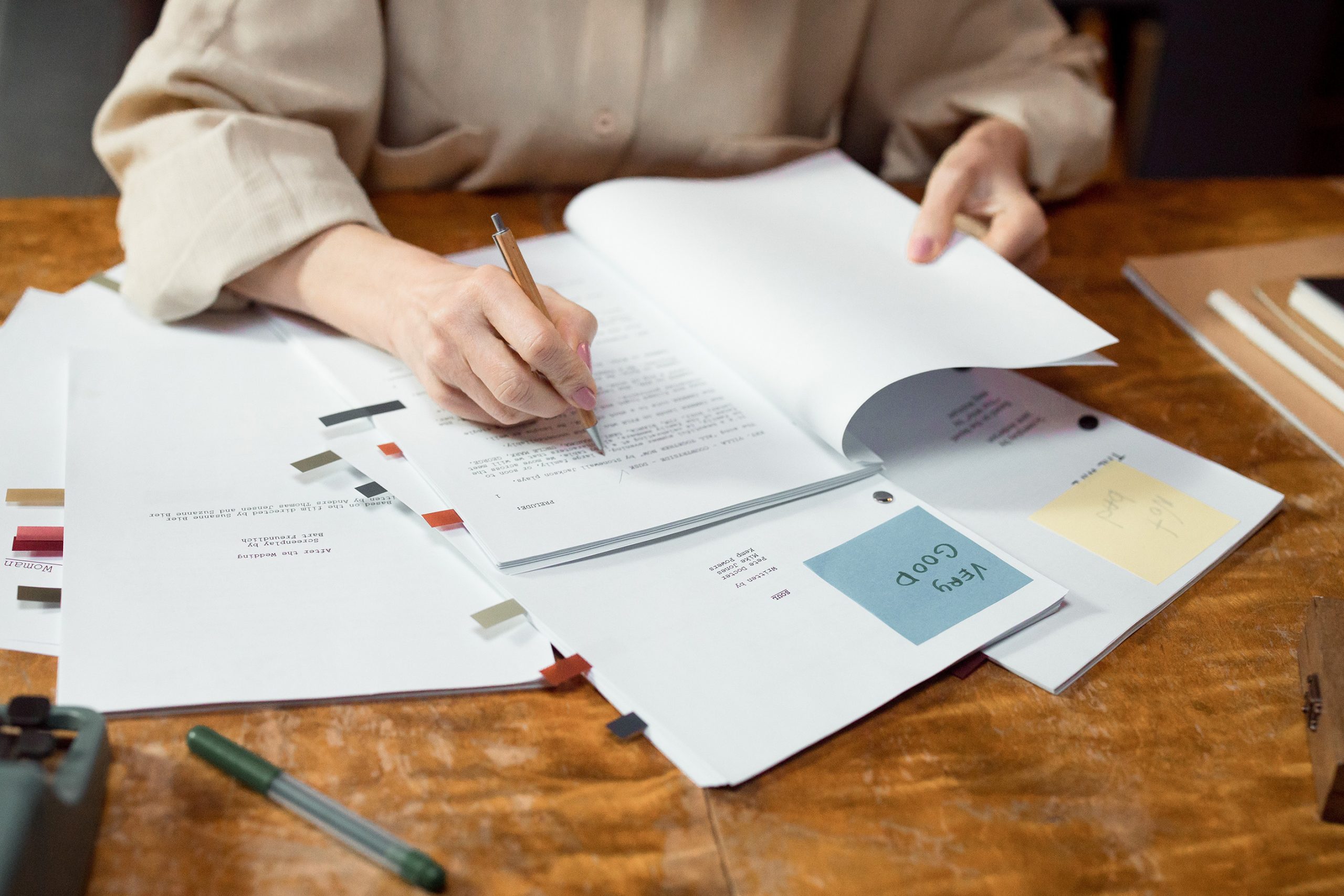 Lady writing on paper for script writing